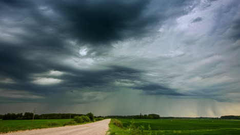 time lapse shot of dark grey clouds covering agricultural field in nature