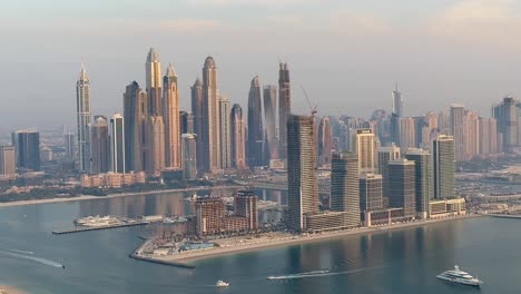 Dubai-Marina's-skyscrapers-framing-the-skyline,-with-boats-gracefully-navigating-the-waters