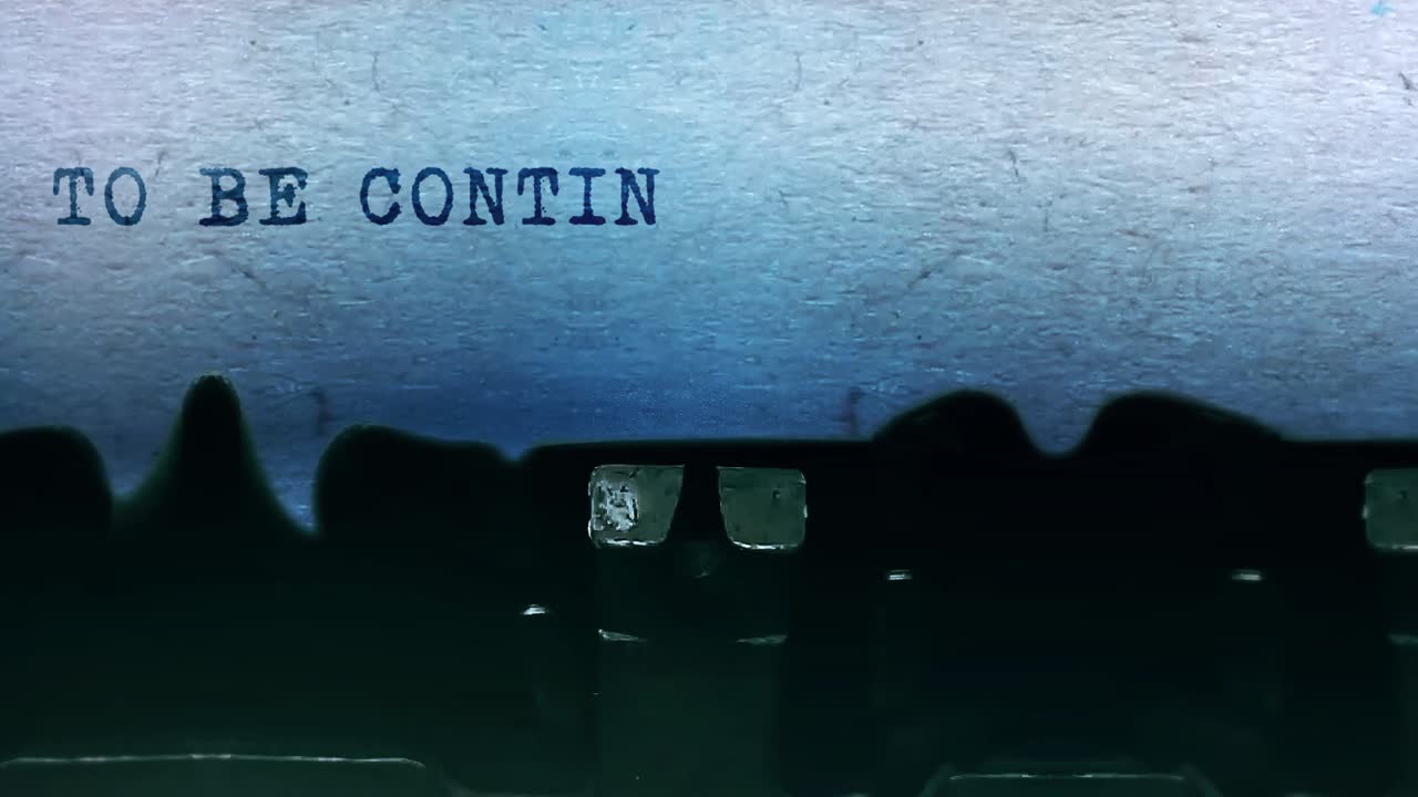To be continued word closeup being typing and centered on a sheet of paper on old vintage typewriter