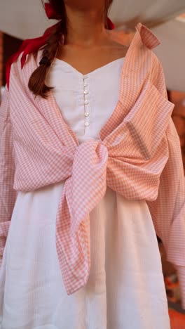 woman in a pink and white plaid shirt dress