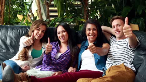 positive friends sitting and thumbs up