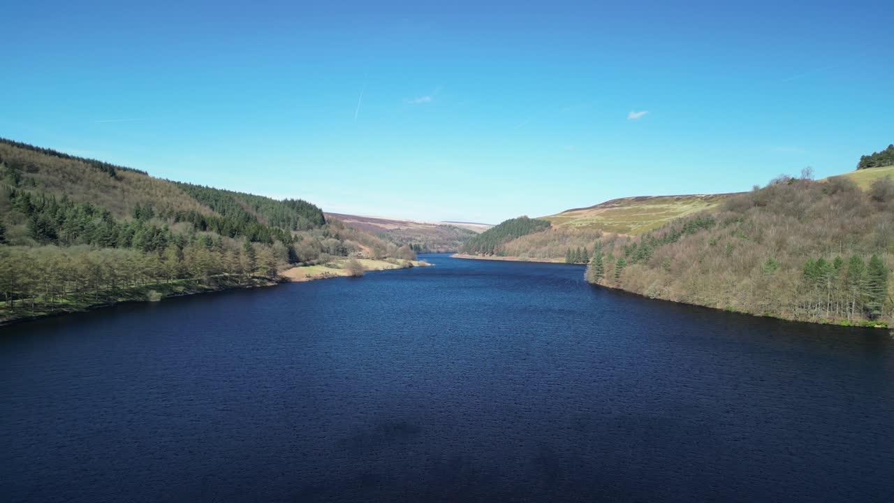 Aerial pull back reveal of the Derwent Dam, from the Derwent Reservoir,home of the Dam Busters practice during the second world war