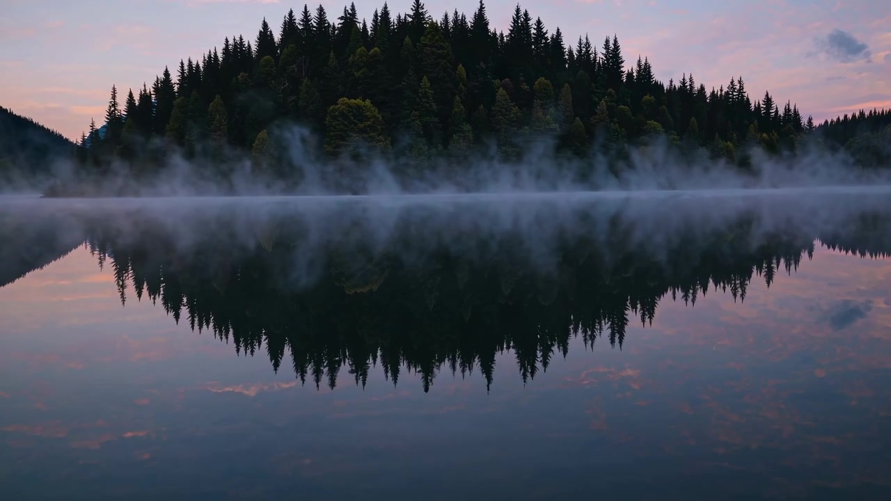 Mist Rising Over a Calm Mountain Lake at Sunrise