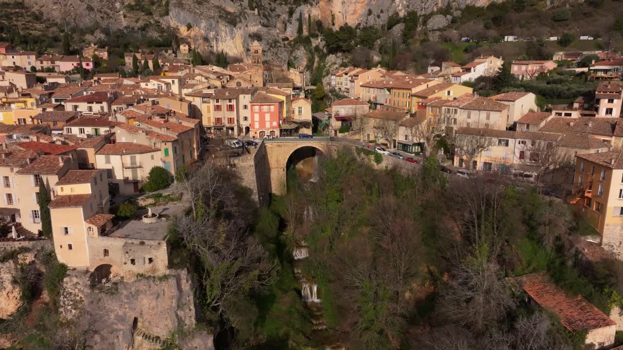 Vista aérea de un pintoresco pueblo construido en laderas de piedra en los Alpes de Alta Provenza.