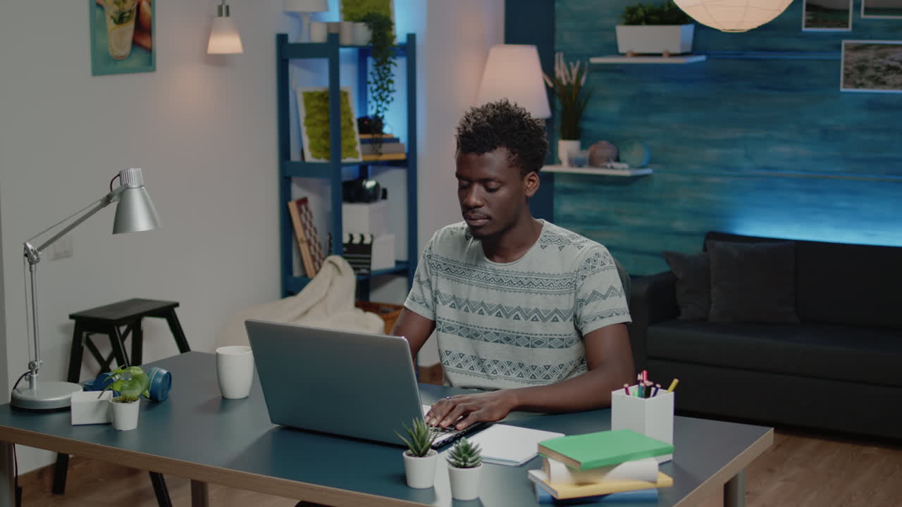 Business man of african ethnicity using laptop for online remote work