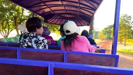 passengers enjoy scenic tram ride in thailand