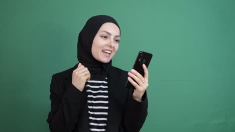 Muslim-Woman-Looking-Phone