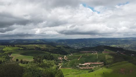 Aerial-descending-over-countryside-with-cultivated-fields-in-Serra-Negra,-Brazil