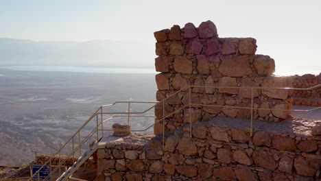 ancient stone fortress ruins with a view of the dead sea and desert landscape