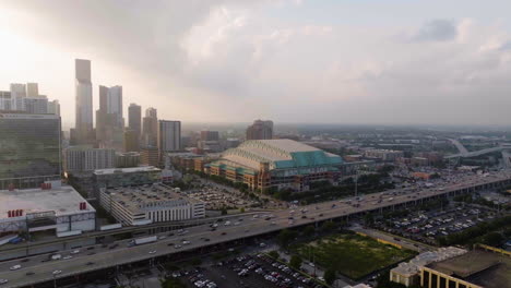 drone rotating in front of the minute maid park, hazy sunset in houston, usa