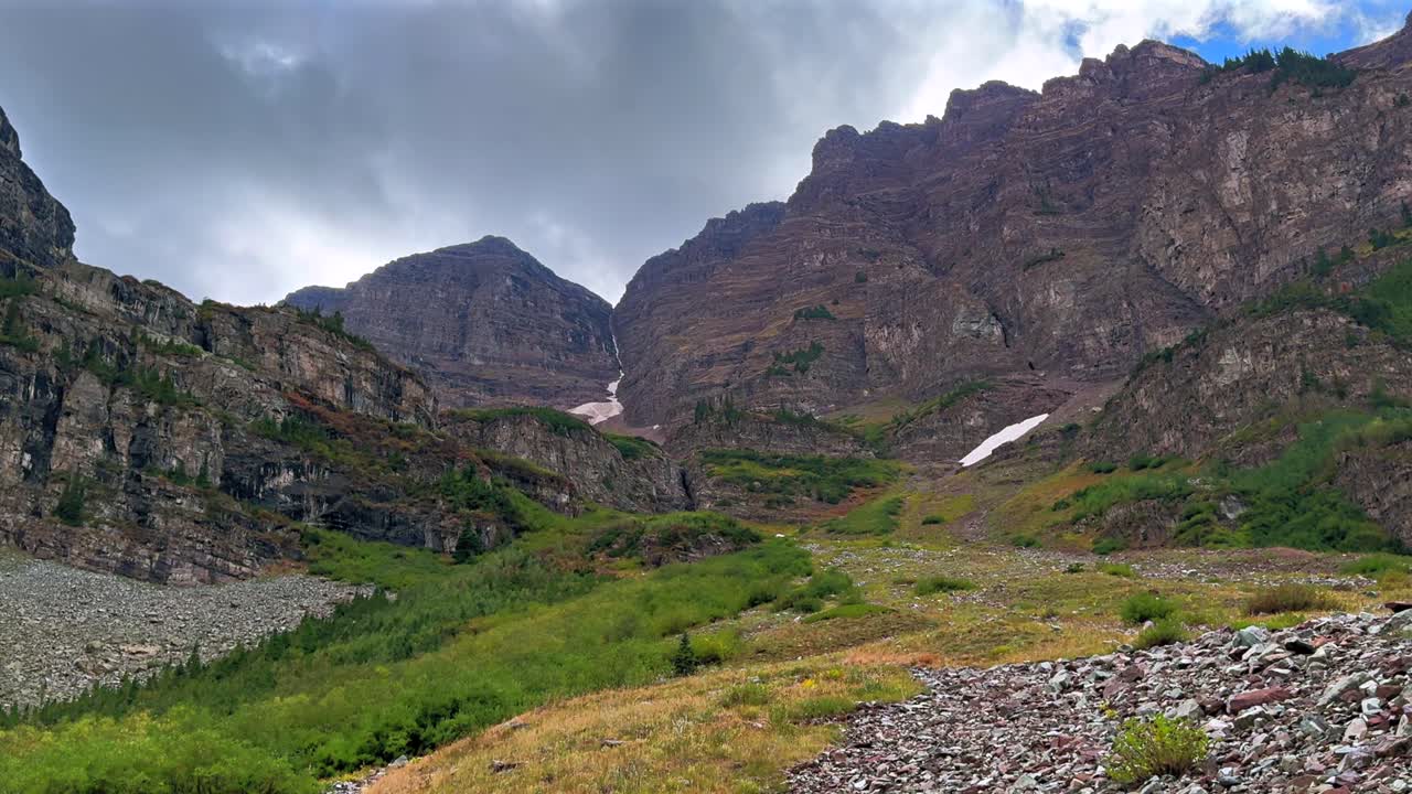 Maroon Bells Wilderness Maroon Peak Crater Lake green summer valley Colorado clouds movement Aspen Snowmass rugged terrain Elk Range Rocky Mountains White River Forest blue sky sunset zoom in