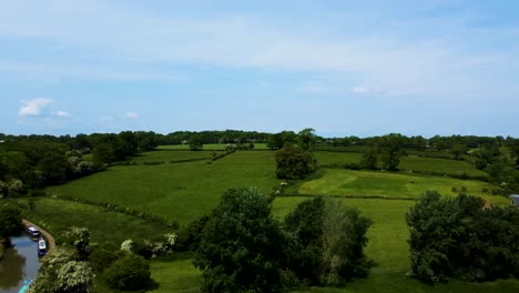 drone rises to reveal stunning farmland pastures in english countryside, stoke bruerne