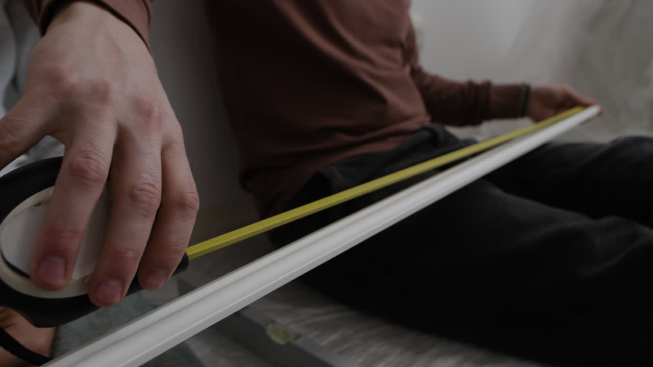 Man Measuring Trim for Home Improvement Project