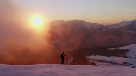 Vista-Aérea-De-Excursionista-Con-Esquí-Caminando-Sobre-La-Cordillera-De-Los-Dolomitas-Nevados-Al-Atardecer