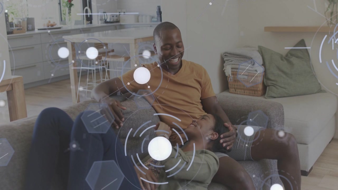 Woman shifting on gray sofa causing man stroking her head, sharing warmth tech overlay moving