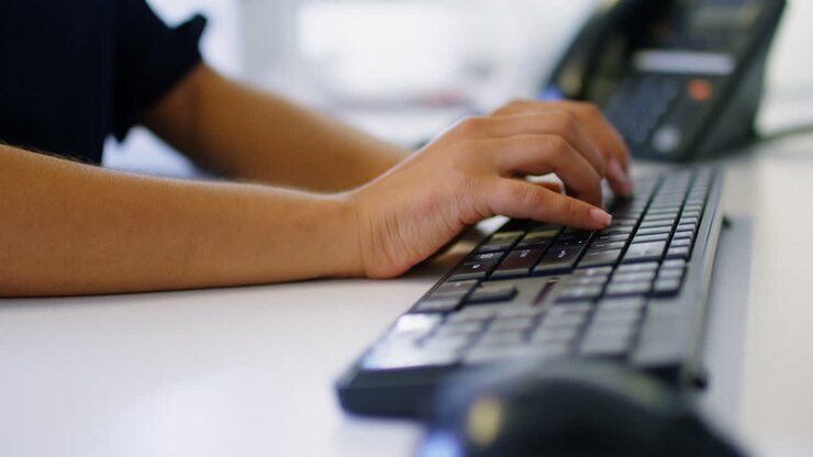 Executive typing on keyboard in office 4k