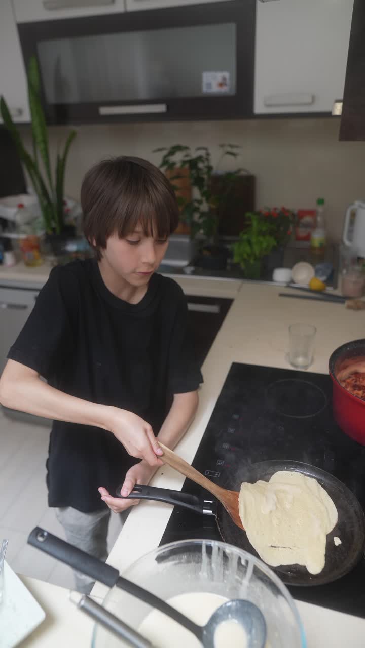 A Young Boy Cooking Pancakes