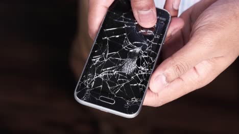 broken smartphone in hands