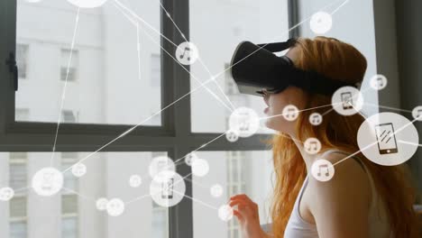 Animation-of-network-of-connections-with-icons-over-woman-wearing-vr-headset