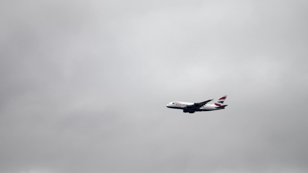 British Airways Airbus A380 flying in cloudy sky with ample negative space