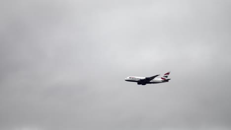 british airways airbus a380 flying in cloudy sky with ample negative space