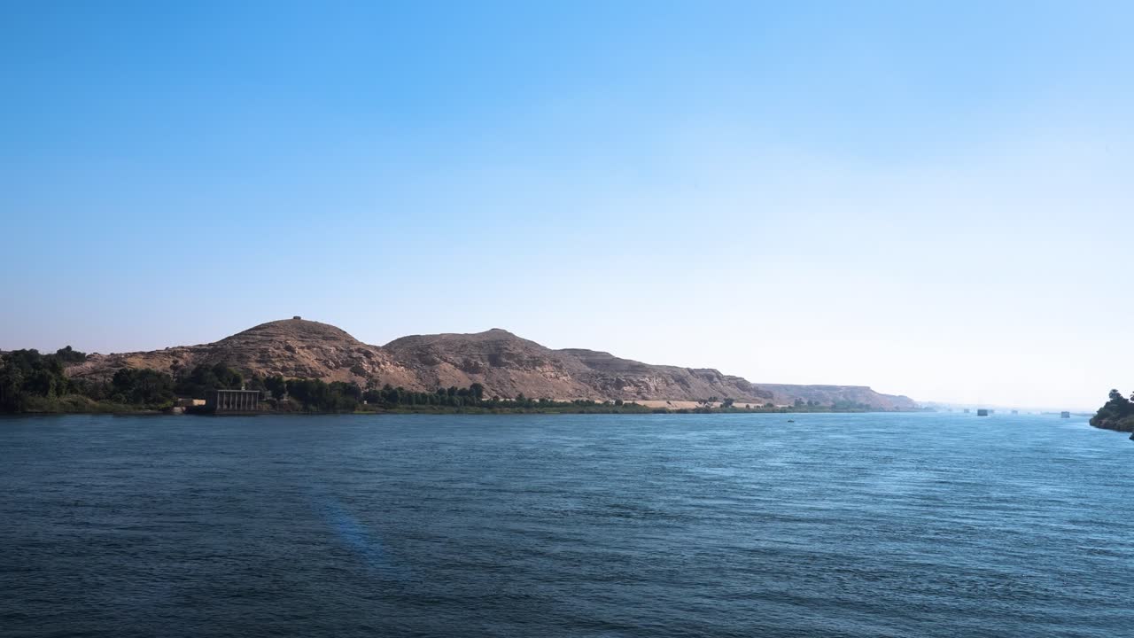 Sailing down the nile river, dramatic downstream view of the mountain range and surrounding nature