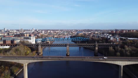 Cars-Driving-Across-Bridges-in-Newcastle-Upon-Tyne-Quayside-on-Sunny-Autumn-Day---Aerial-Drone-4K-HD-Footage-Zoom-Out