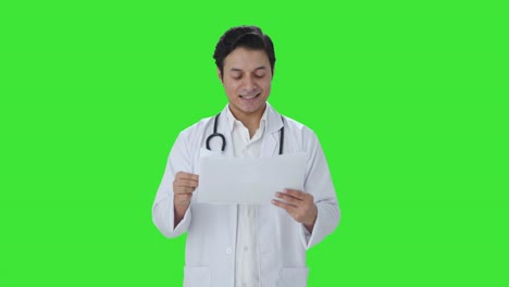 Happy-Indian-doctor-checking-medical-reports-Green-screen