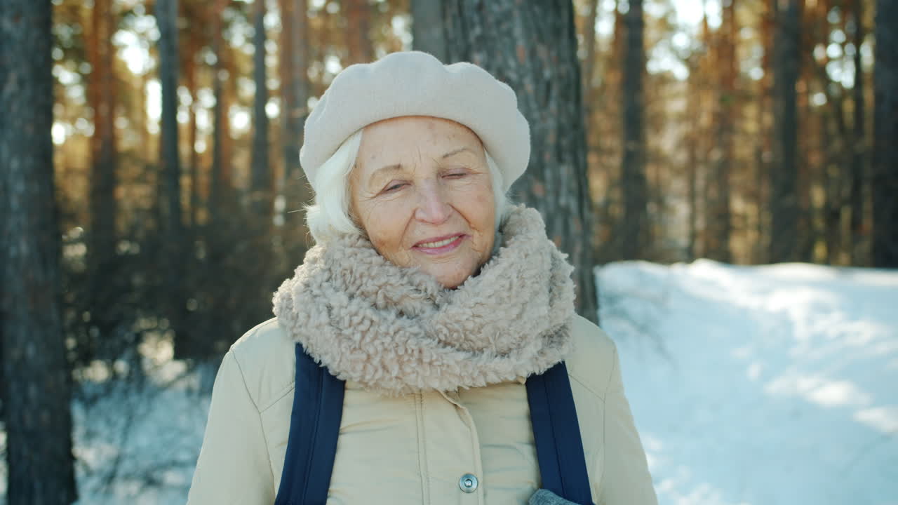 Smiling Senior Woman in Winter Forest