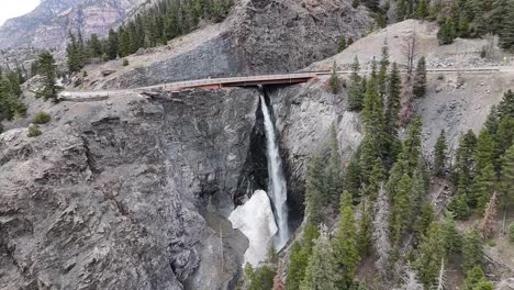 Aerial-View-of-waterfall-on-the-side-of-the-Road,-Bear-Creek-Falls-in-Ouray-Colorado