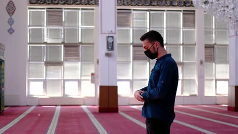 man worships in a mask in a mosque