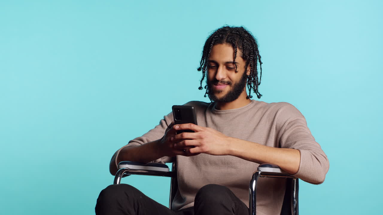 Person with paraplegia talking with mate in video call, studio background