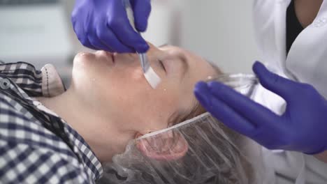 cosmetologist smoothes wrinkles with microcurrent. hardware procedure in cosmetology. peeling, phonophoresis, massage and facelift in a beauty clinic.