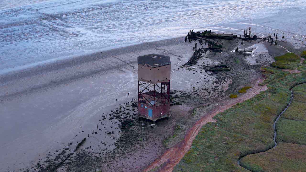 East Tilbury radar tower aerial view circling the River Thames marshland foreshore landmark