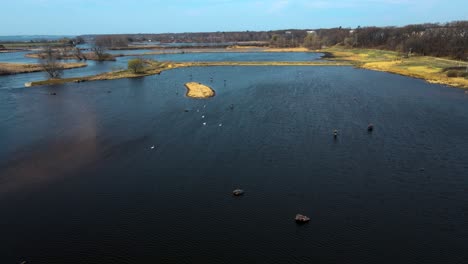 west facing forward track with drone over the mouth of muskegon river