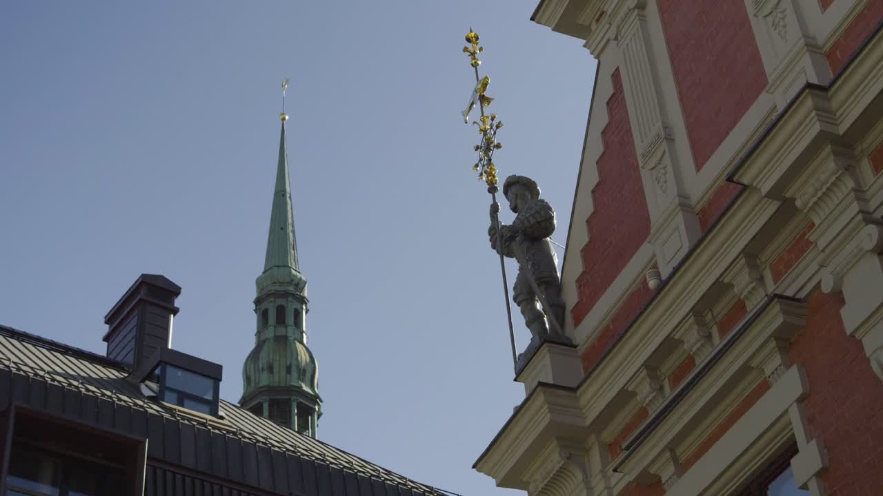 Cinematic reveal of blackheads house in Riga with church in background