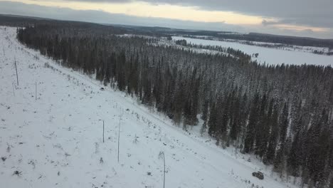 cars driving through a snow covered landscape near kuusamo, finland