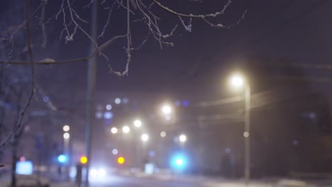 Winter-street-light-at-night,-establisher-shot-of-snowy-city,-blurred-background