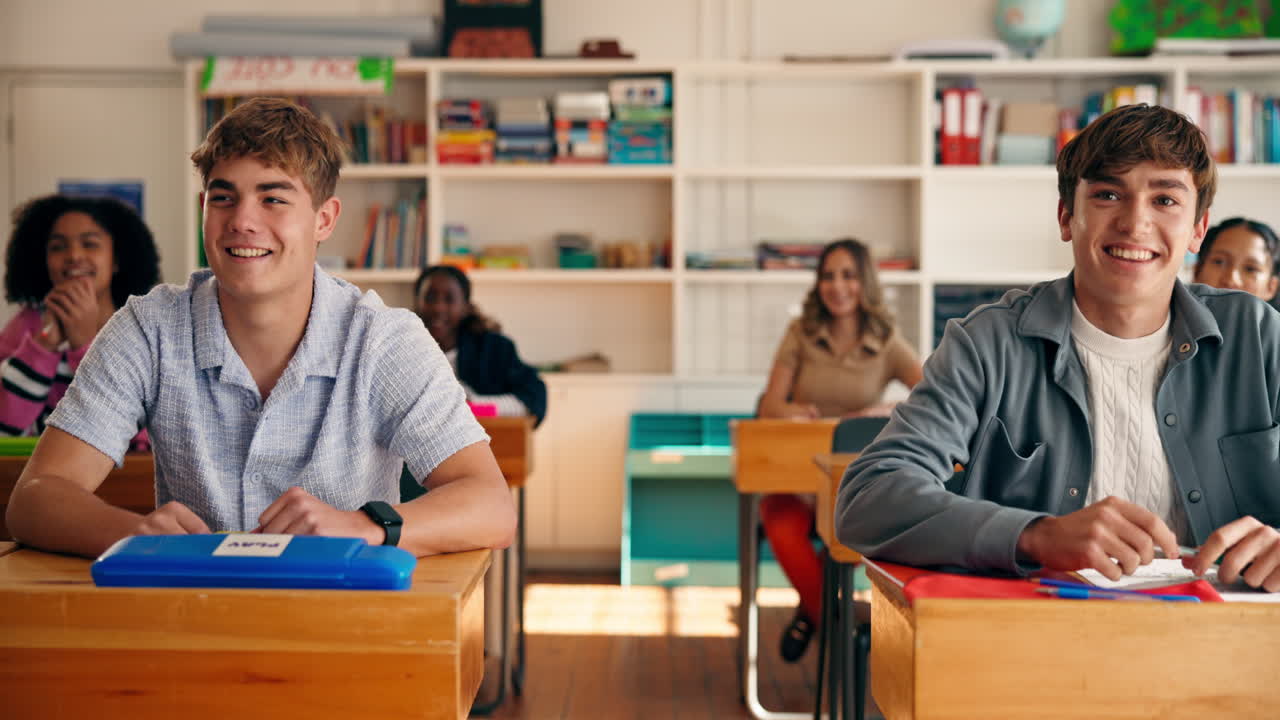 Students in a classroom raising their hands