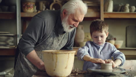 grandfather and grandson in a pottery workshop