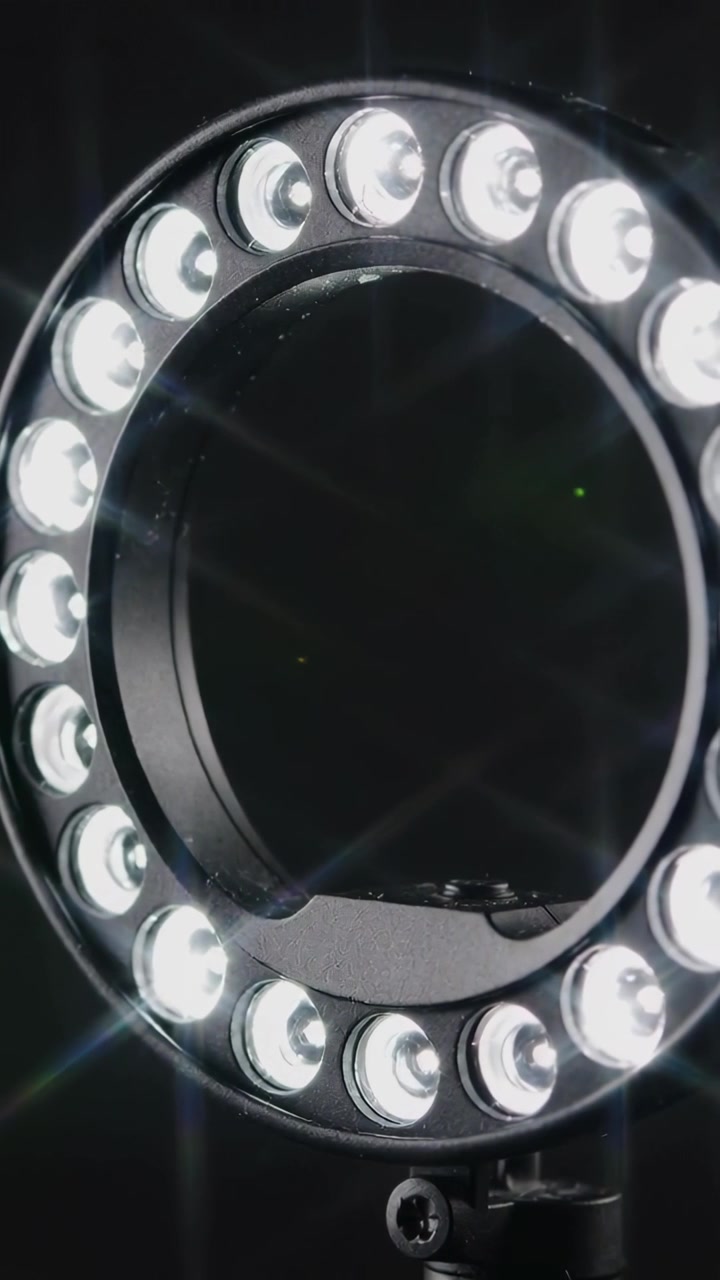 Vertical video: Shifting camera capturing LED ring light in studio to reveal flares and mount screw