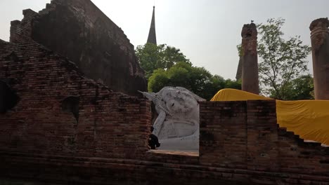 static view of a buddha statue among historical ruins