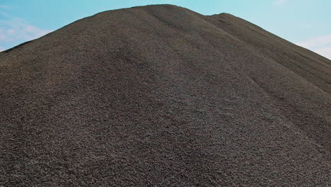 crushed stone in mining plant. close up of huge hills of crushed stone