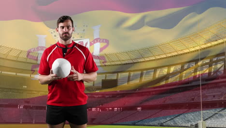 professional rugby player standing in front of a flag and stadium