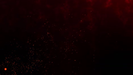 las chispas ardientes rojas que se elevan del fuego sobre un fondo negro. partículas brillantes de fuego abstracto animación 4k.