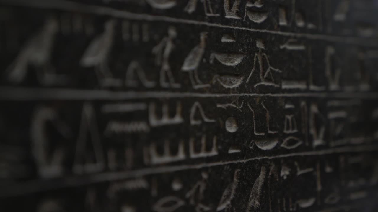 Macro close up of ancient Egyptian hieroglyphics written on giant tablet