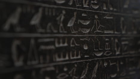 macro close up of ancient egyptian hieroglyphics written on giant tablet