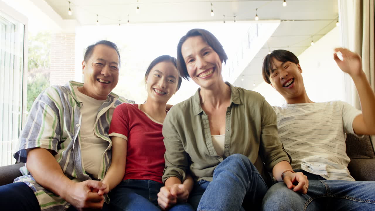 Smiling family sitting together on couch, enjoying quality time indoors