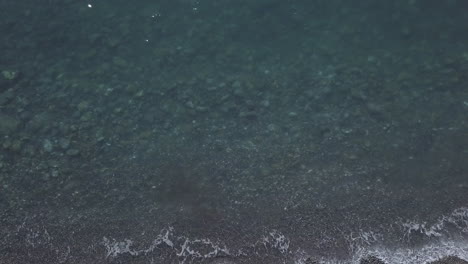 transparent clear sea in the rocky beach shore aerial view