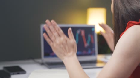 investor looking at the stock market chart. she claps when she wins.